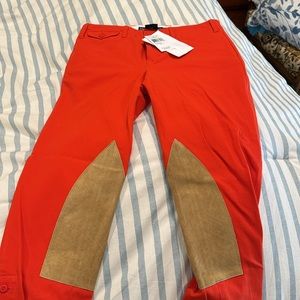 Ralph Lauren:Cropped pants orange and Swede trim, buttons on side of the calves